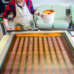 Sarah Waterhouse, silkscreen textile printer at work in her studio 2019